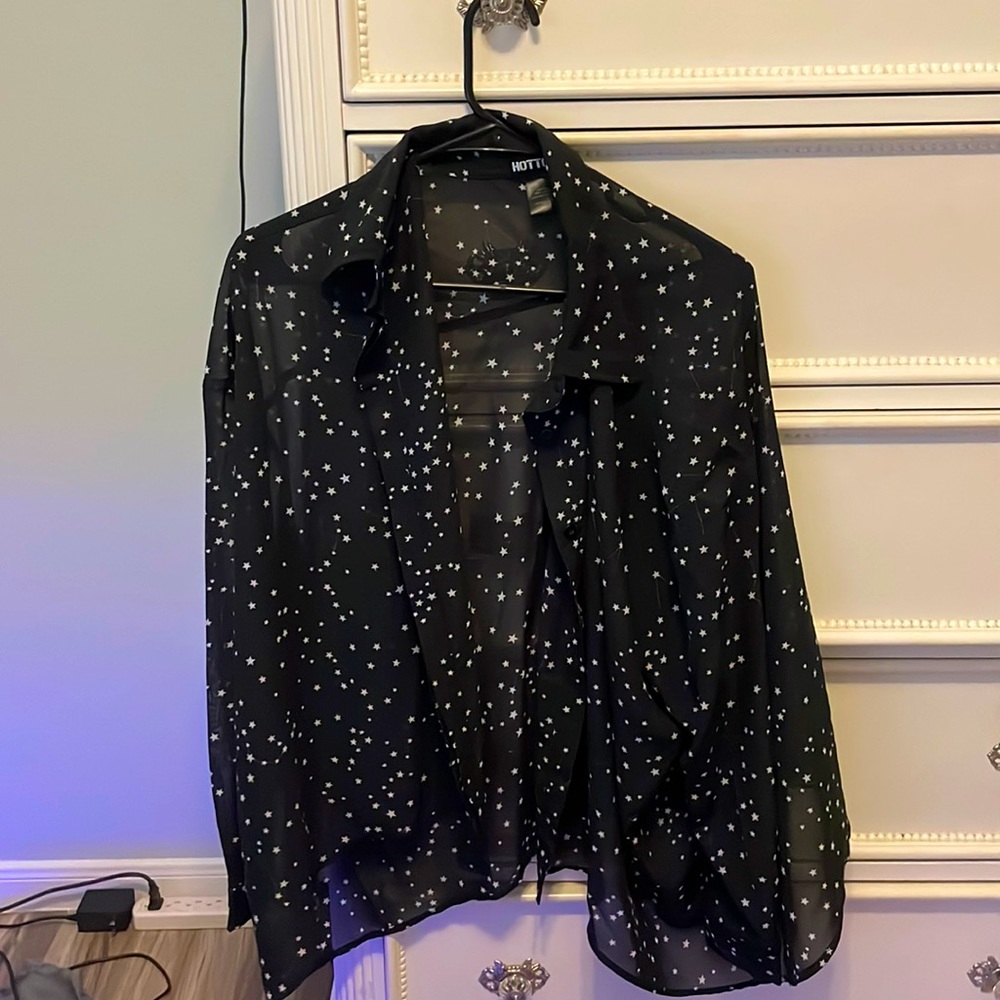 A navy blue long sleeve sheer button down shirt with white stars